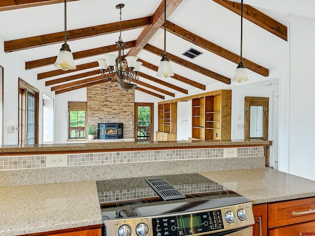 kitchen featuring a healthy amount of sunlight, a large fireplace, and pendant lighting