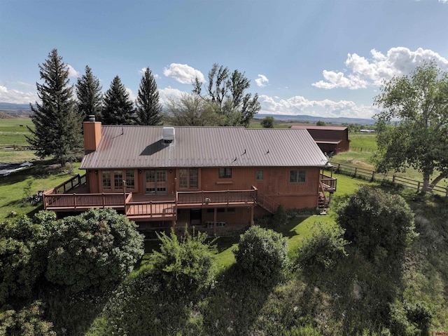 back of house featuring a yard and a wooden deck