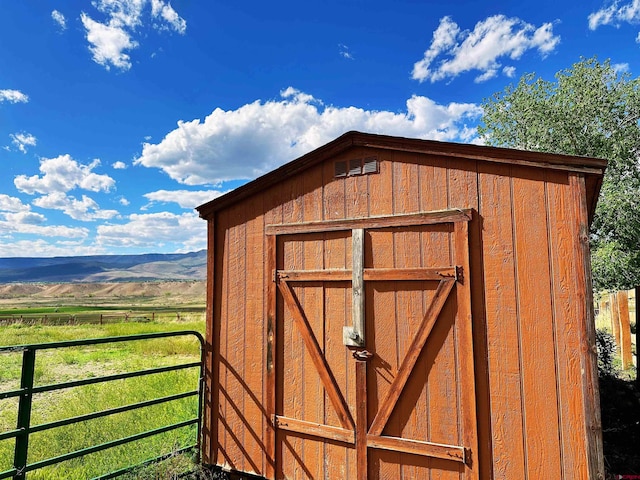 view of shed / structure featuring a mountain view and a rural view