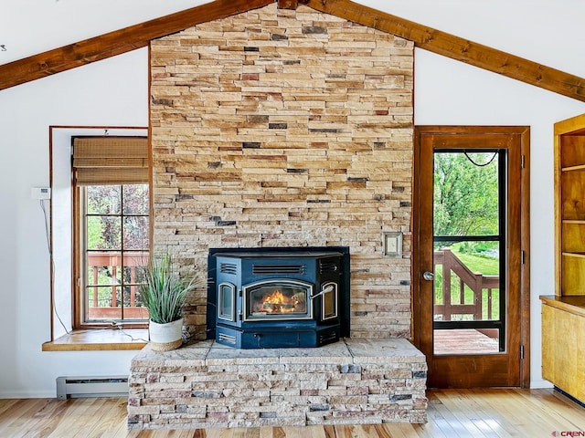 details featuring beamed ceiling, hardwood / wood-style floors, a baseboard radiator, and a wood stove