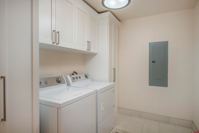 laundry area featuring washer and dryer, cabinets, and light tile floors