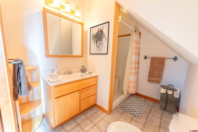 bathroom featuring tile flooring, vanity, and toilet