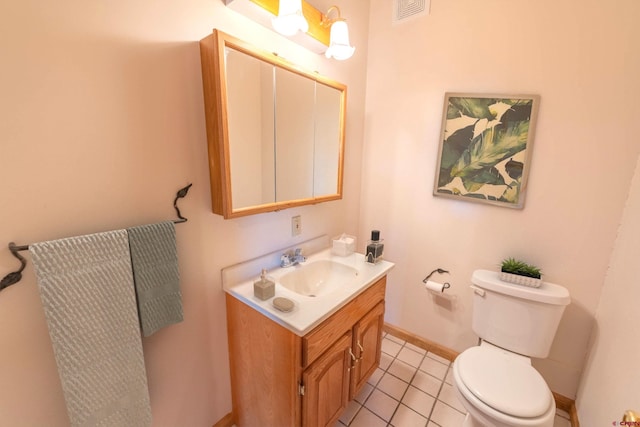 bathroom featuring tile floors, toilet, and oversized vanity