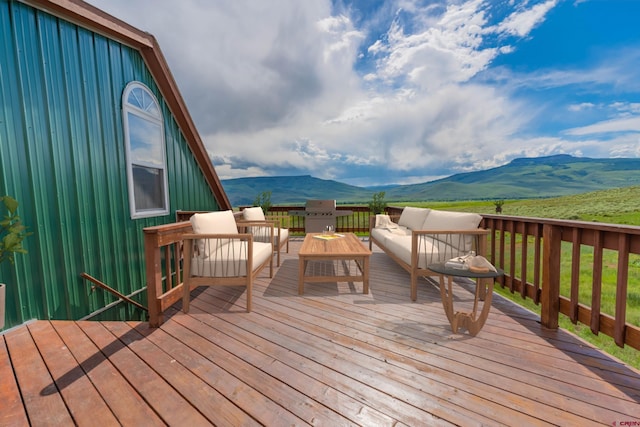 wooden deck featuring a yard, an outdoor hangout area, and a mountain view