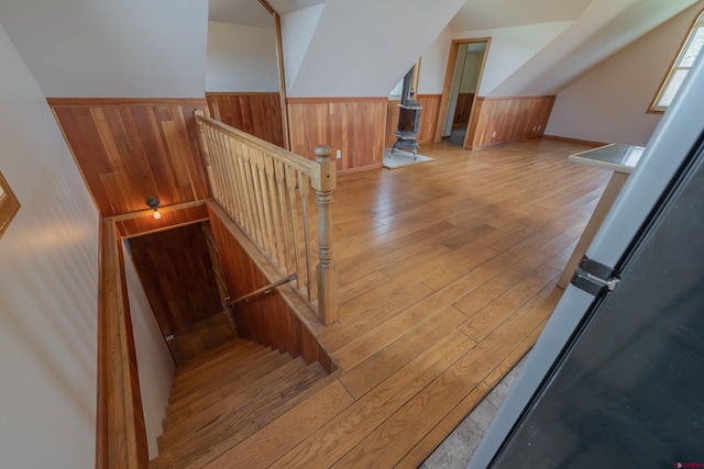 stairway with wood walls and hardwood / wood-style floors