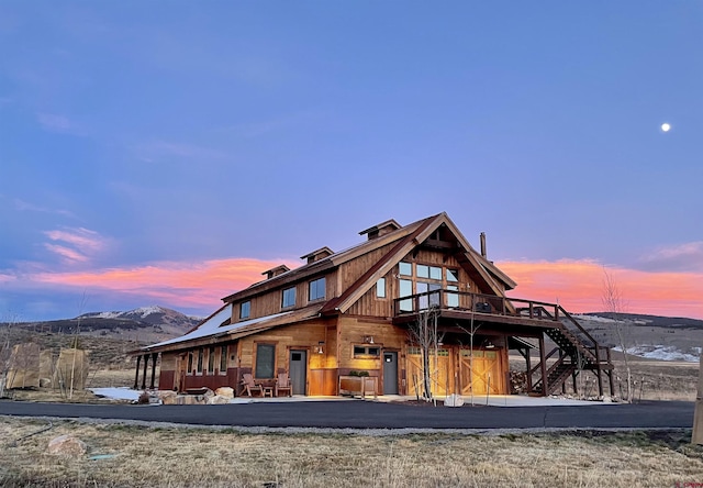 back house at dusk with a mountain view