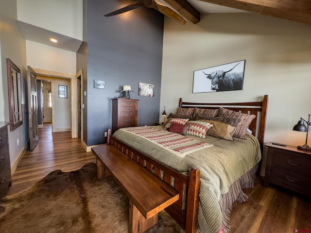 bedroom with dark hardwood / wood-style floors, beamed ceiling, ceiling fan, and high vaulted ceiling