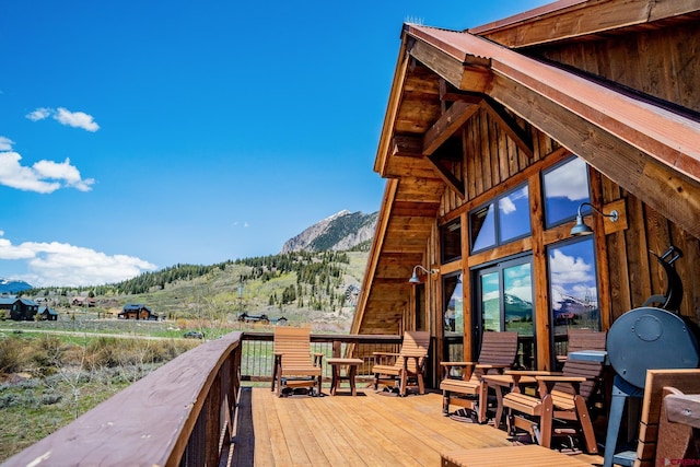 wooden terrace featuring a mountain view
