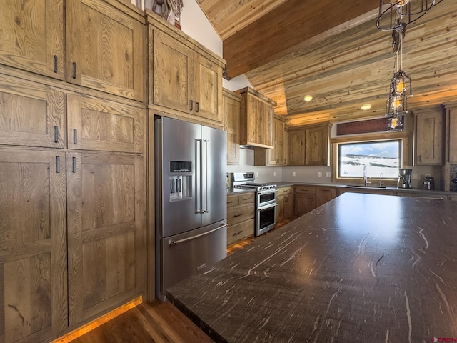 kitchen featuring stainless steel appliances, hanging light fixtures, dark wood-type flooring, sink, and lofted ceiling