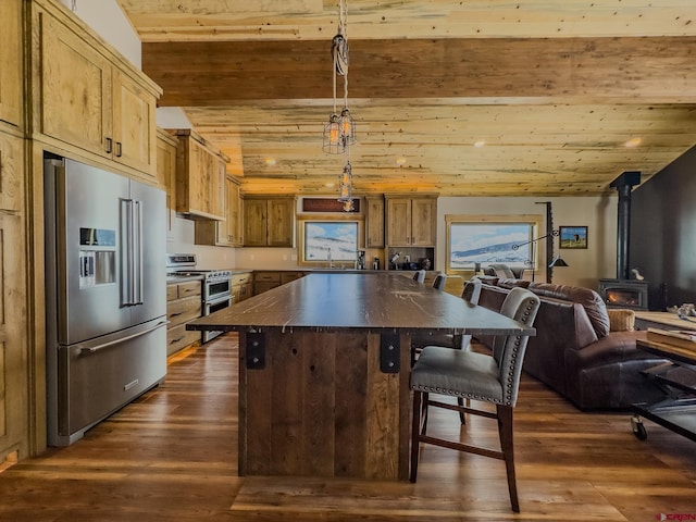 kitchen with appliances with stainless steel finishes, wood ceiling, a wood stove, and dark hardwood / wood-style flooring