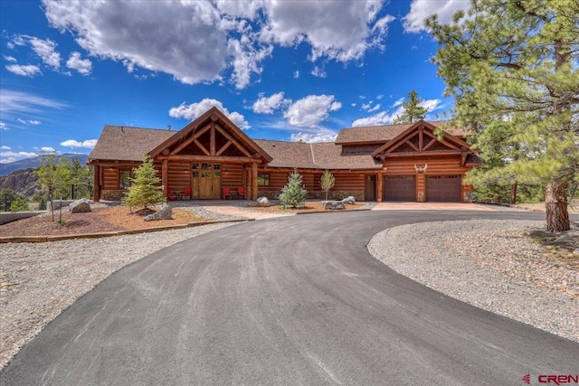 log home featuring a garage