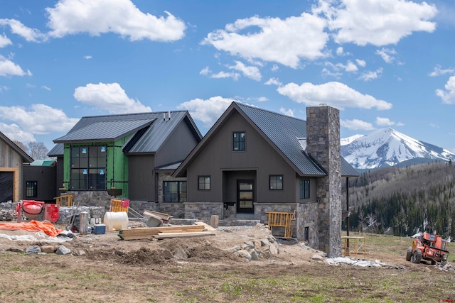 back of property with a mountain view