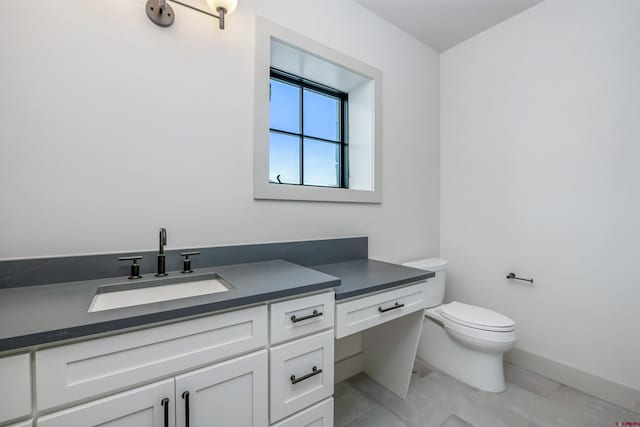 bathroom with tile patterned floors, vanity, and toilet