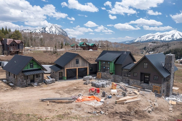 rear view of property featuring a mountain view and an outbuilding