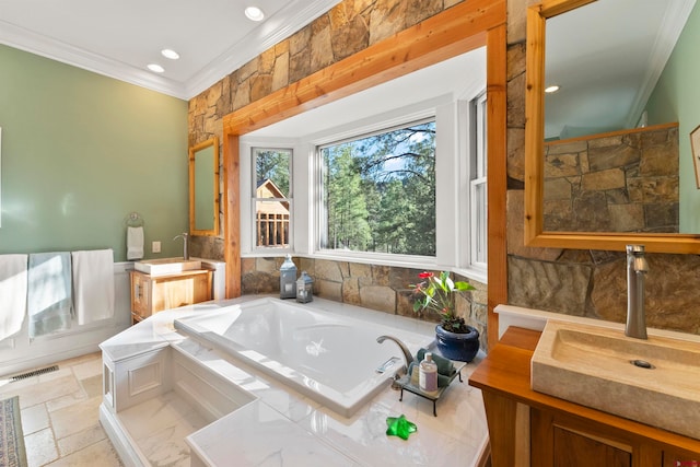 bathroom with tile floors, tiled bath, ornamental molding, and vanity