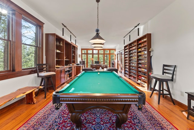 recreation room with pool table and light hardwood / wood-style floors