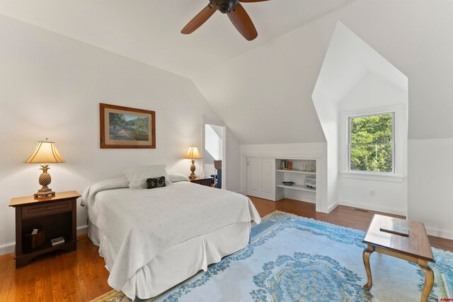 bedroom with lofted ceiling, wood-type flooring, and ceiling fan