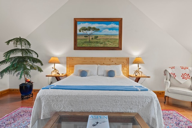 bedroom featuring lofted ceiling and wood-type flooring