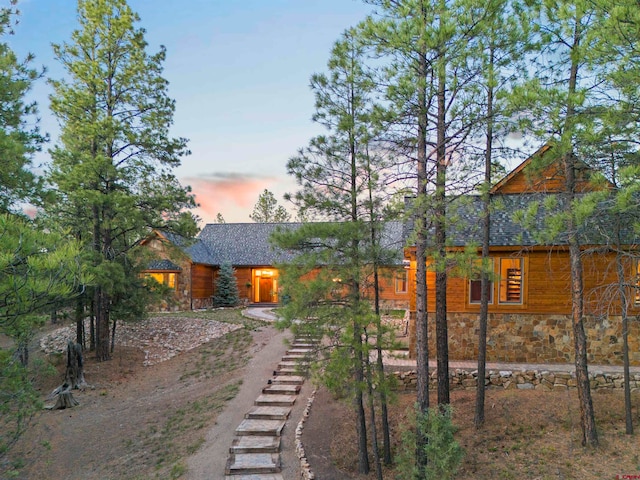 view of back house at dusk