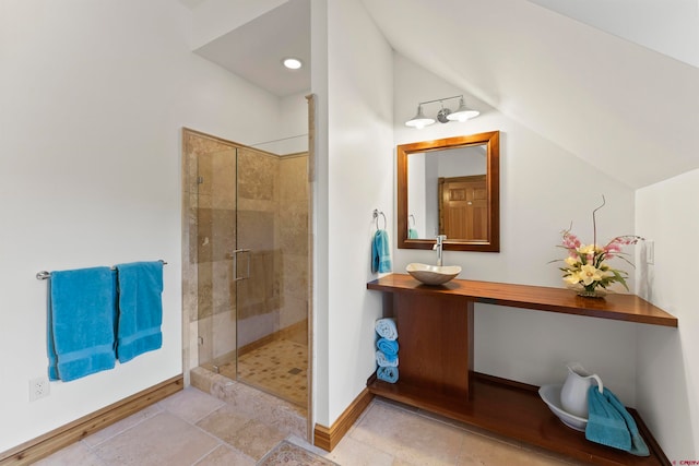 bathroom featuring tile floors, a shower with door, lofted ceiling, and vanity