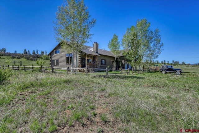 101 Spirit Path Ct, Pagosa Springs, CO 81147 - back of property featuring log siding, a chimney, and a rural view