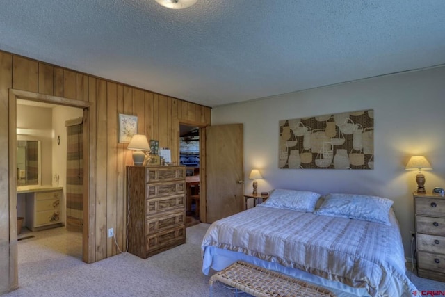 101 Spirit Path Ct, Pagosa Springs, CO 81147 - carpeted bedroom featuring wooden walls, a textured ceiling, and ensuite bath