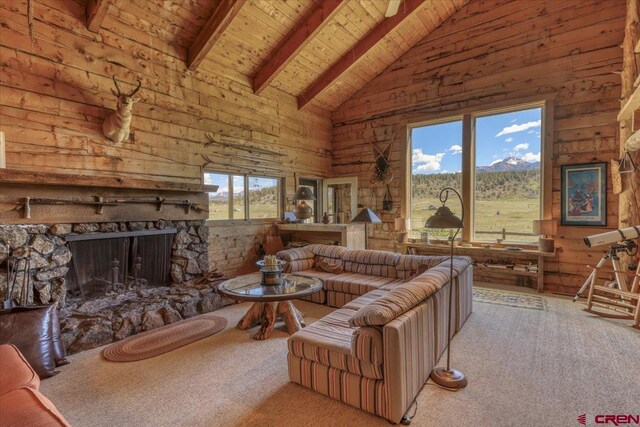 101 Spirit Path Ct, Pagosa Springs, CO 81147 - living area featuring wood ceiling with exposed beams, a fireplace, carpet floors, high vaulted ceiling, and a mountain view