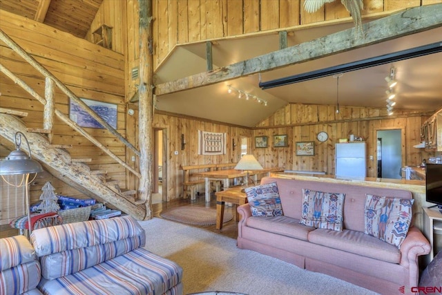 101 Spirit Path Ct, Pagosa Springs, CO 81147 - living room with wooden walls, lofted ceiling, rail lighting, carpet floors, and stairway