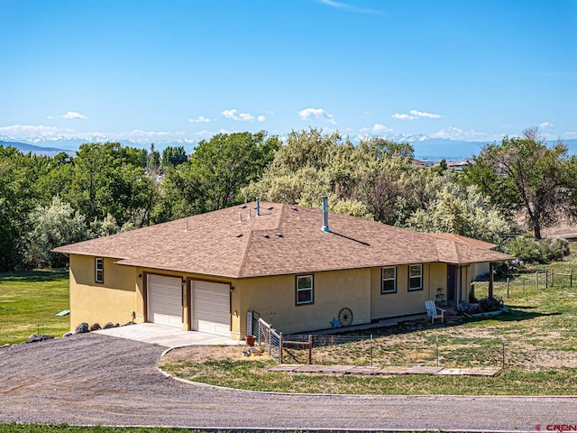 ranch-style home featuring a front yard and a garage