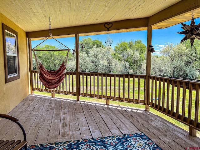 wooden deck with a lawn