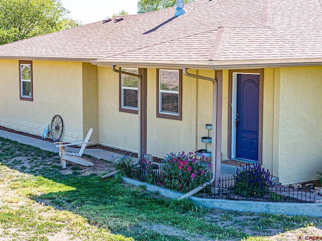 doorway to property featuring a yard