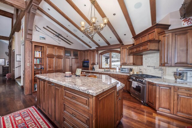 kitchen with beam ceiling, a center island, a chandelier, decorative light fixtures, and high end stainless steel range