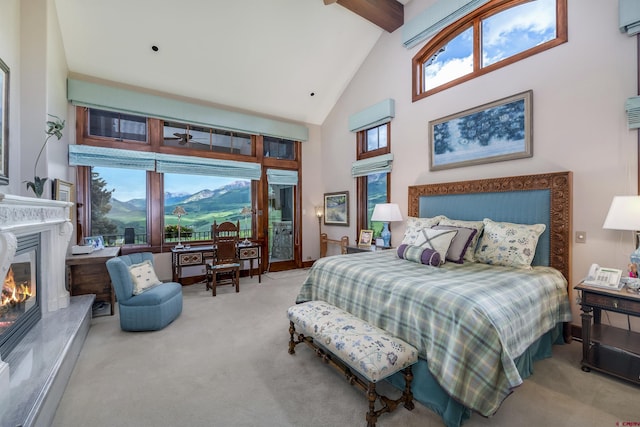 carpeted bedroom featuring multiple windows, a fireplace, high vaulted ceiling, and beamed ceiling