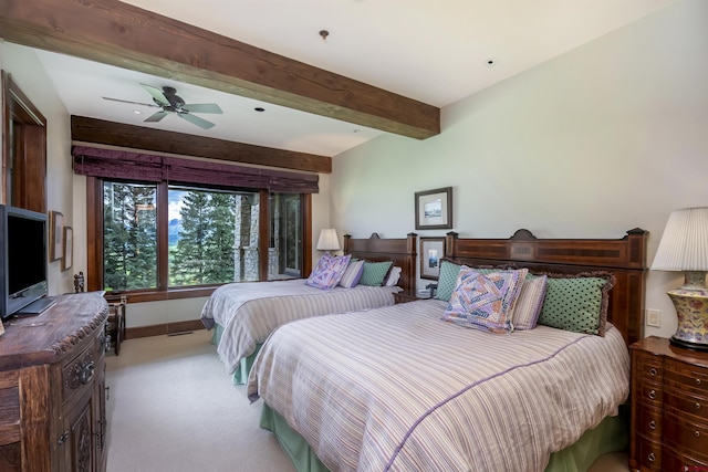 bedroom with beamed ceiling, ceiling fan, and light colored carpet