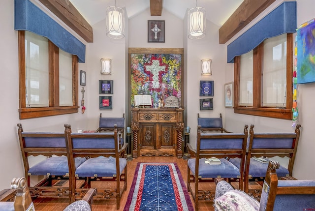 sitting room featuring vaulted ceiling with beams and hardwood / wood-style flooring