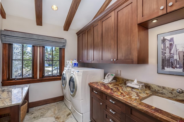 laundry area featuring cabinets, sink, and washer and dryer