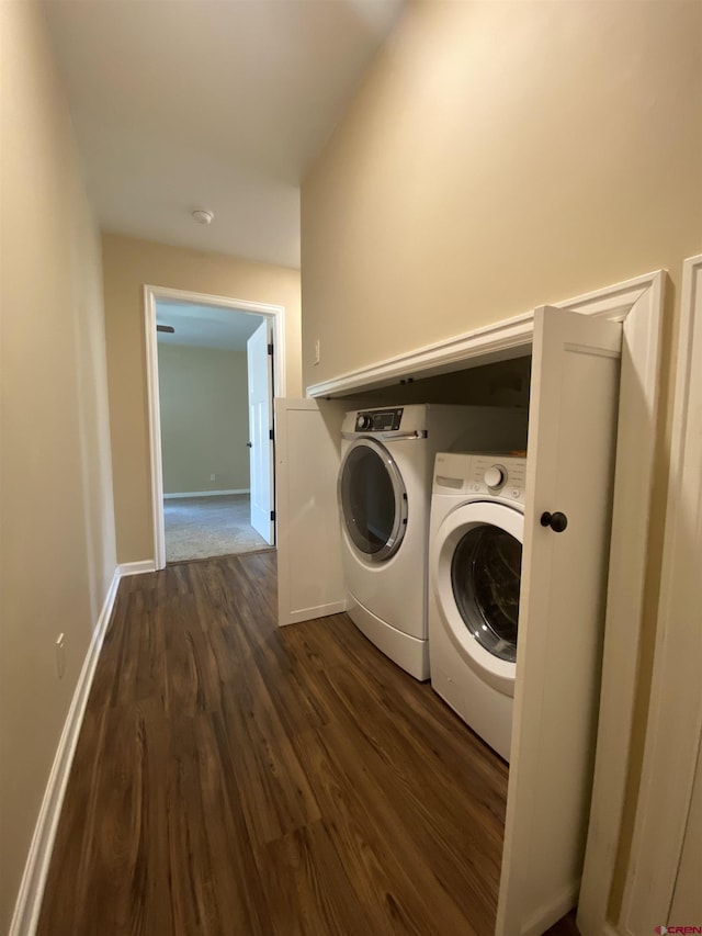 laundry area with dark wood-type flooring and washing machine and clothes dryer