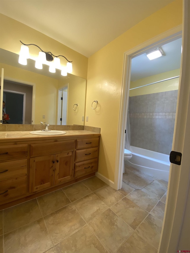 full bathroom featuring vanity, toilet, and tiled shower / bath