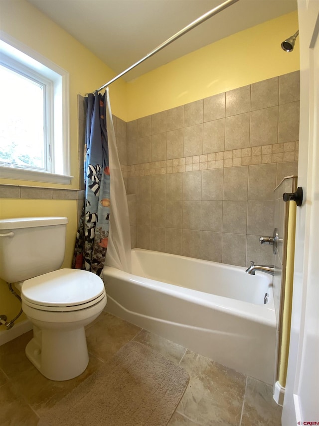 bathroom with shower / tub combo, toilet, and tile patterned floors