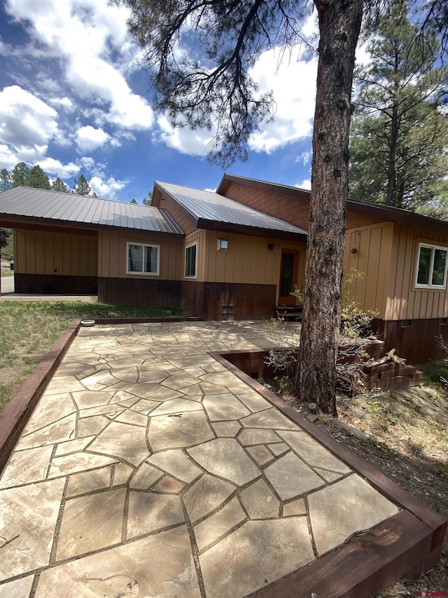 back of house with a patio