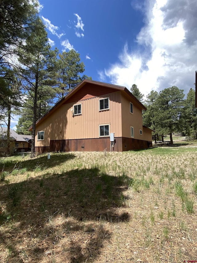 view of property exterior featuring a lawn