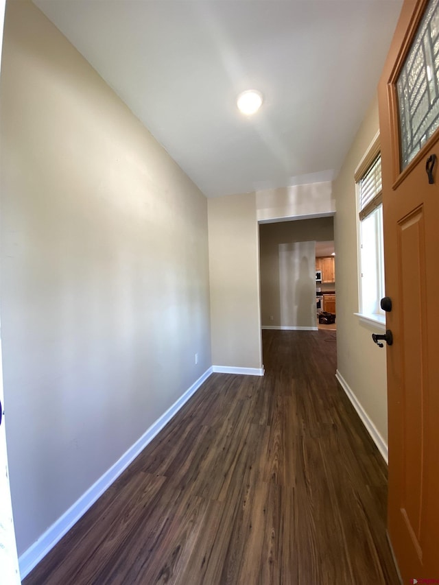 corridor with dark hardwood / wood-style floors