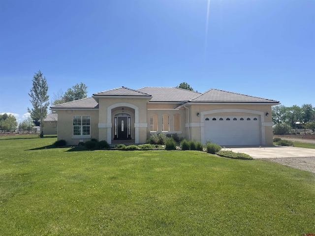 view of front of home with a garage and a front yard