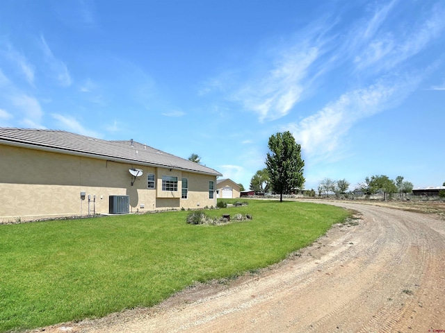 exterior space with cooling unit and a yard