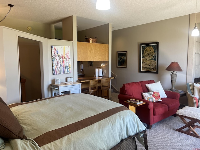 bedroom featuring carpet floors and a textured ceiling