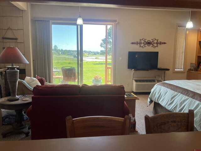 carpeted bedroom featuring access to outside