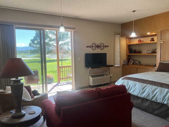 bedroom with access to outside and a textured ceiling