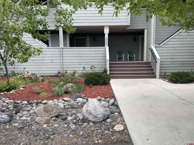 view of exterior entry featuring a porch