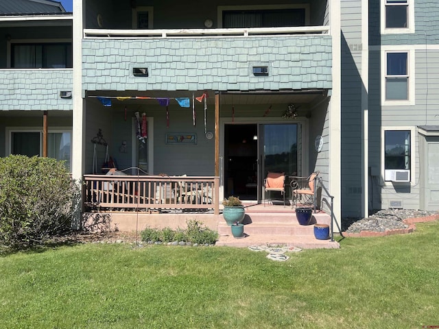 entrance to property with a lawn and cooling unit