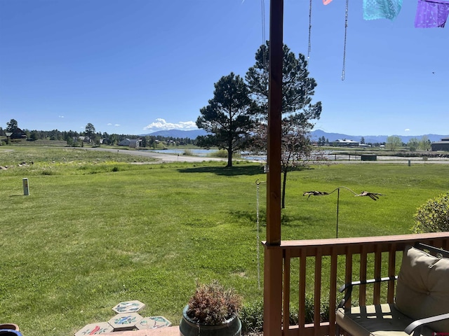 view of yard with a rural view and a water and mountain view